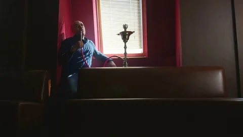 The Guy Portrait Smoking Hookah in a Bar Breath out Smoke Slow Motion Stock Footage 75258423