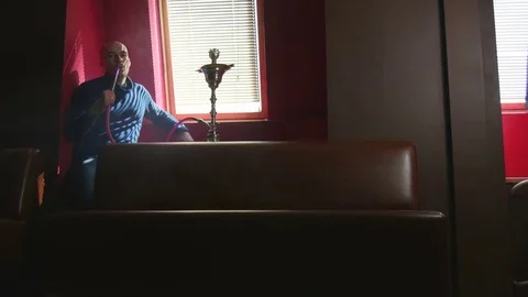 The Guy Portrait Smoking Hookah in a Bar Breath out Smoke Slow Motion Stock Footage 75258461