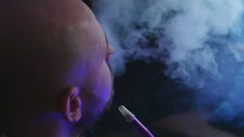 The Guy Portrait Smoking Hookah in a Bar Breath out Smoke Stock Footage 75259076
