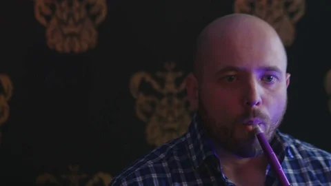 The Guy Portrait Smoking Hookah in a Bar Breath out Smoke Stock Footage 75259120