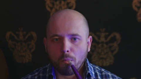 The Guy Portrait Smoking Hookah in a Bar Breath out Smoke Stock Footage 75259166