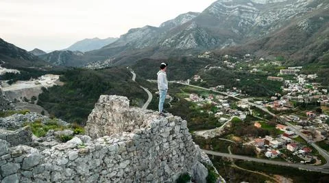 The guy poses against the backdrop of the mountains of Montenegro Stock Photos