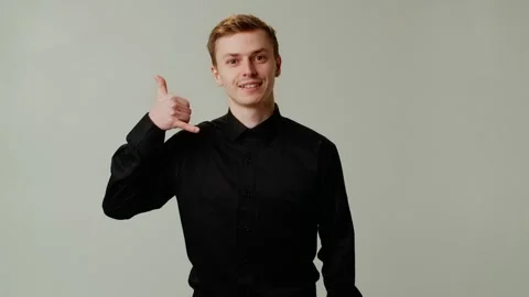 A guy in positive mood flirts and invites a date. A young businessman boss Stock Footage 252880384