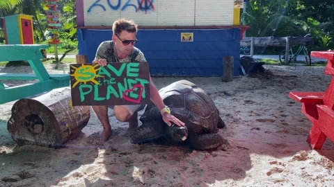 A guy with a poster in his hands that says "Save the Planet" Stock Footage 154767502