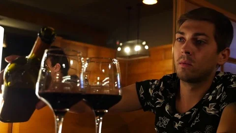 The guy pours wine on a date Stock Footage 80545453