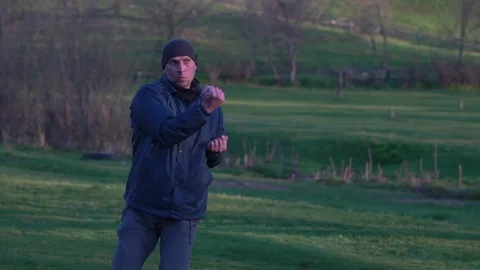 Guy Practices the Kyokushin Style of Karate in the Early Spring at Dawn Stock Footage 74693153