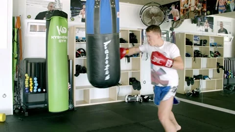 Guy is practicing blows. In the boxing gym, kickboxing Stock Footage 141184916