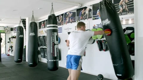 Guy is practicing blows. In the boxing gym, kickboxing Stock Footage 141184924