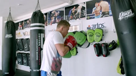 Guy is practicing blows. In the boxing gym, kickboxing Stock Footage 141184971
