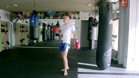 Guy is practicing blows. In the boxing gym, kickboxing Stock Footage 141185001