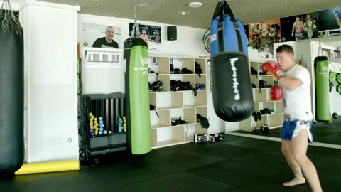 Guy is practicing blows. In the boxing gym, kickboxing Stock Footage 141185027
