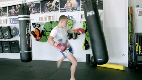 Guy is practicing blows. In the boxing gym, kickboxing Stock Footage 141185048
