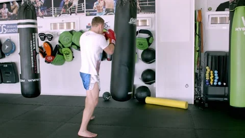 Guy is practicing blows. In the boxing gym, kickboxing Stock Footage 141185061