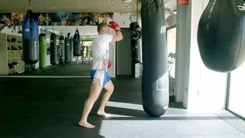 Guy is practicing blows. In the boxing gym, kickboxing Stock Footage 141185080