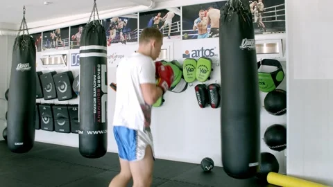 Guy is practicing blows. In the boxing gym, kickboxing Stock Footage 141185107