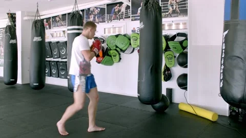 Guy is practicing blows. In the boxing gym, kickboxing Stock Footage 141185114