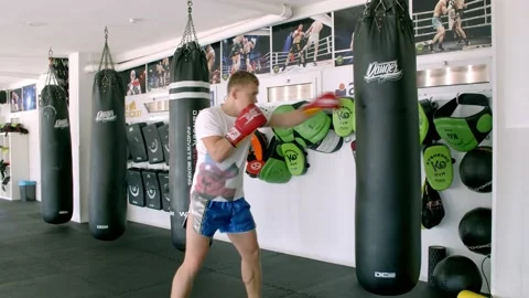 Guy is practicing blows. In the boxing gym, kickboxing Stock Footage 141185129