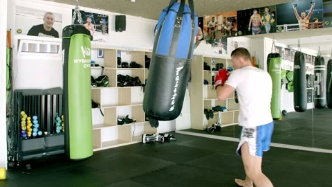 Guy is practicing blows. In the boxing gym, kickboxing Stock Footage 141185144