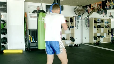 Guy is practicing blows. In the boxing gym, kickboxing Stock Footage 141185155