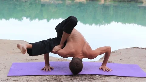 The guy is practicing yoga in the woods Stock Footage 95334881