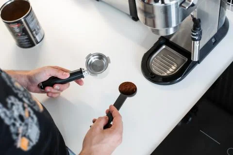 Guy prepare delicious aromatic coffee in a coffee machine. A simple way to ma Stock Photos