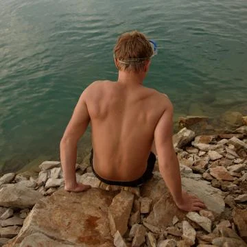 The guy is preparing to go into the water Stock Photos