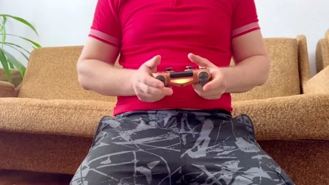 The guy presses buttons on the gamepad Stock Footage 195955780