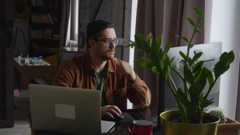 Guy programmer writes code on a computer at home Stock Footage 150455943