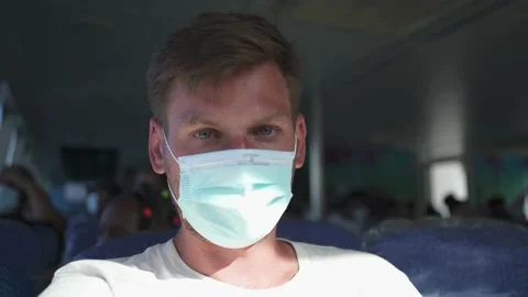 A guy in a protective mask from the coronavirus Stock Footage 155797384