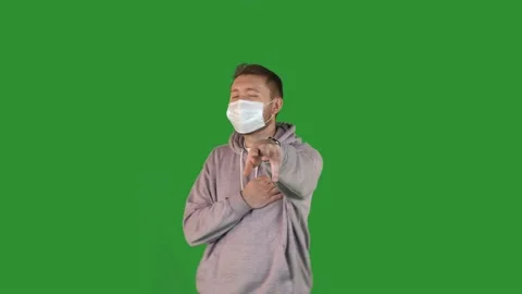 The guy in the protective mask is dancing on a green background in a good mood Stock Footage 167544105