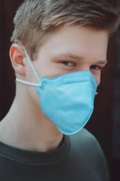 The guy in the protective mask looks into the camera Stock Photos