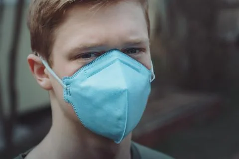 The guy in the protective mask looks into the camera Stock Photos