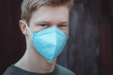 The guy in the protective mask looks into the camera Stock Photos