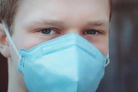 The guy in the protective mask looks into the camera Stock Photos