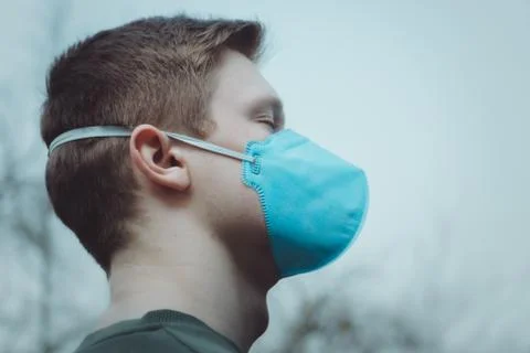 The guy in the protective mask on the sky background Stock Photos