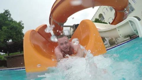 The Guy Pulls Himself Off The Slide Into The Water Stock-Footage 91593262
