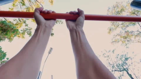 The guy pulls himself up on the sports field. From the first person. Stock Footage 316845357