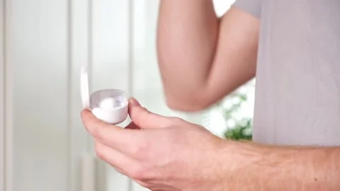 Guy pulls out case and inserts wireless headphones into ears. Young man showing Stock Footage 239816862