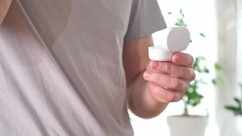 Guy pulls out case and inserts wireless headphones into ears. Young man showing Stock Footage 239816977