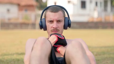 The guy is pumping his abs and looking at the camera. Slow motion video. Video stock 231336951