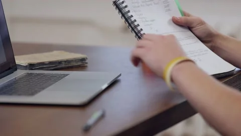 The guy put the cup down on the table. Workplace with laptop and notepad. Stock Footage 146378469