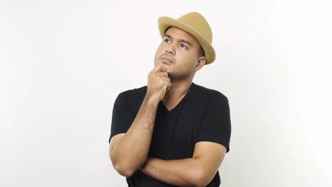 Guy put on hat in casual clothes touching chin, scratching head while thinking o Stock Footage 144651278