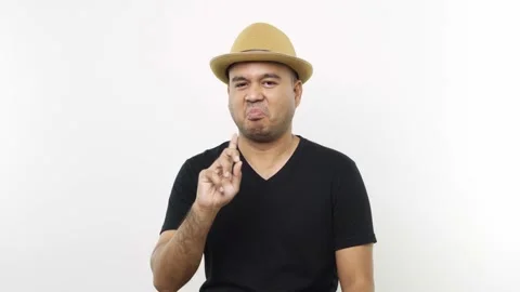 Guy put on hat in casual clothes disapproving with no finger sign make negation  Stock Footage 144651361