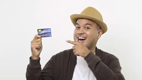 Guy put on hat in casual clothes hold in hand credit bank card get thumb up for  Stock Footage 144651606