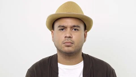 Guy put on hat in casual clothes Suffer from music make a loud noise at all time Stock Footage 144651693