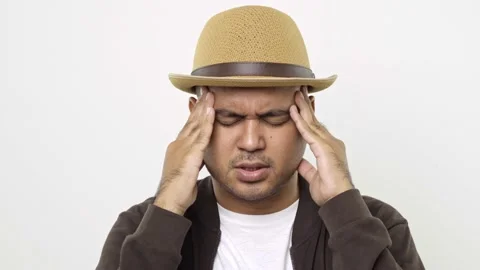  Guy put on hat in casual clothes calming down relieving headache emotional stre Stock Footage 144651981