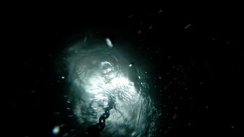 The guy puts a bucket on a chain at the bottom of the well for water intake. Stock Footage 113754235