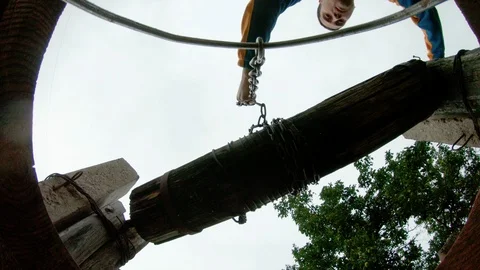 The guy puts a bucket on a chain at the bottom of the well for water intake. Stock Footage 113754595