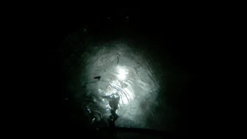 The guy puts a bucket on a chain at the bottom of the well for water intake. Stock Footage 113754642