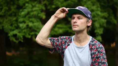 Guy Puts on a Cap Video stock 52195927